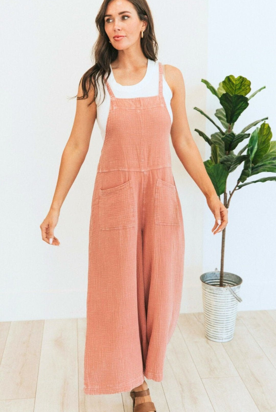 Brunette model in Soft coral corduroy overalls