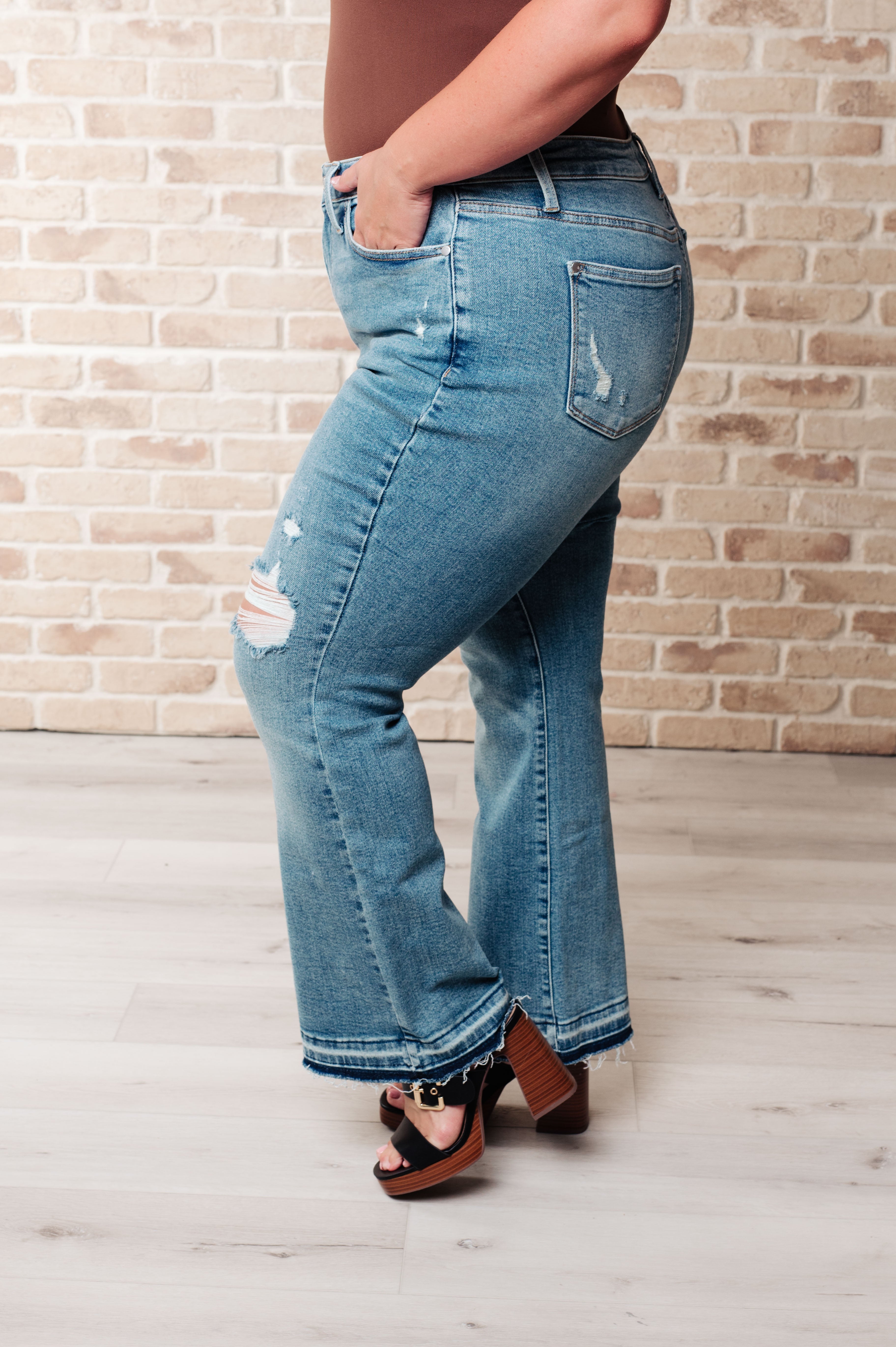 Judy Blue Mid Rise Distressed Released Hem Bootcut Jeans - Isla  on model Jordan 14W