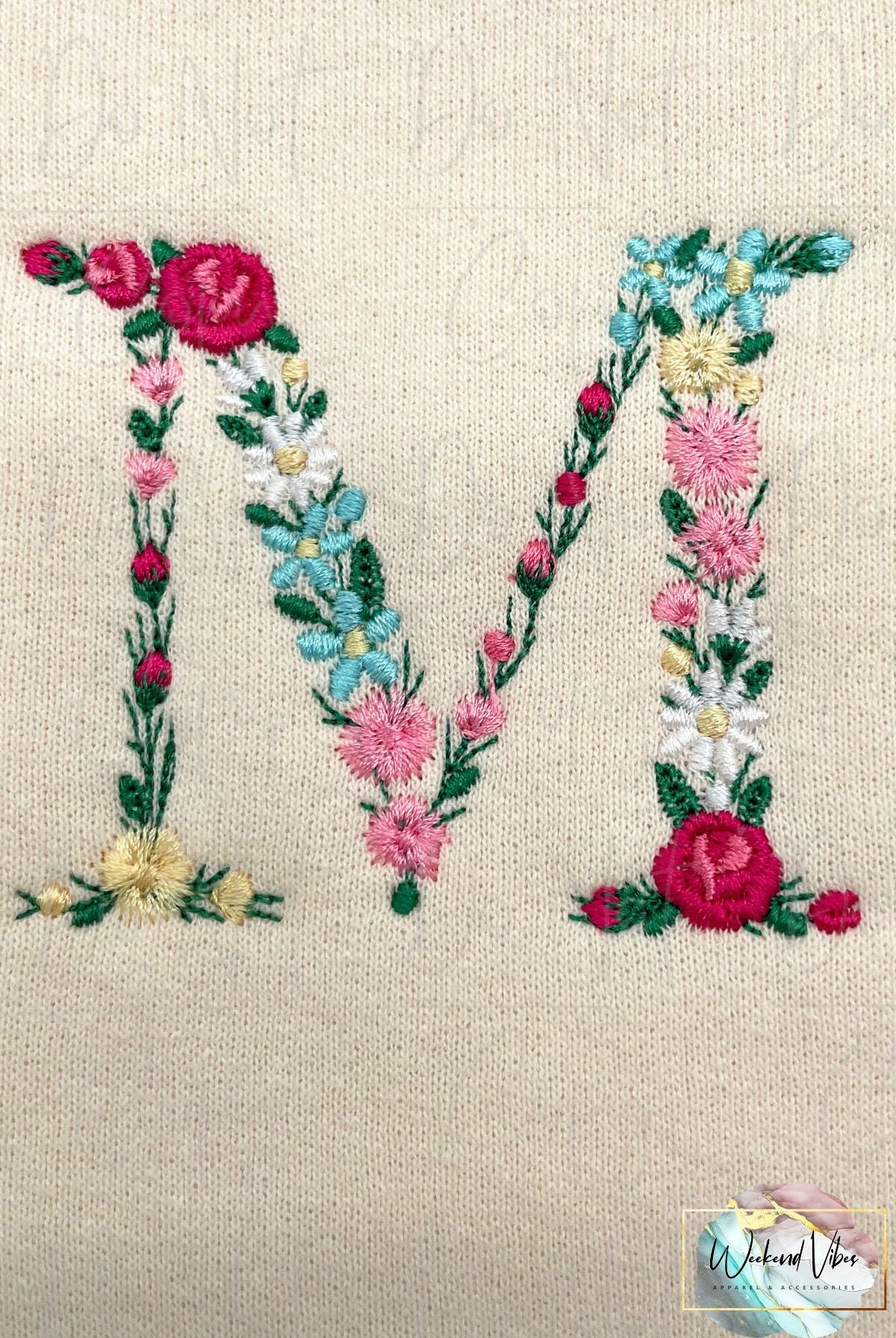 Close up photo of M in Mama floral design sweatshirt