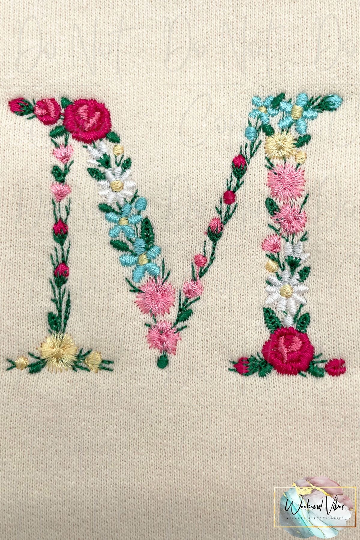 Close up photo of M in Mama floral design sweatshirt