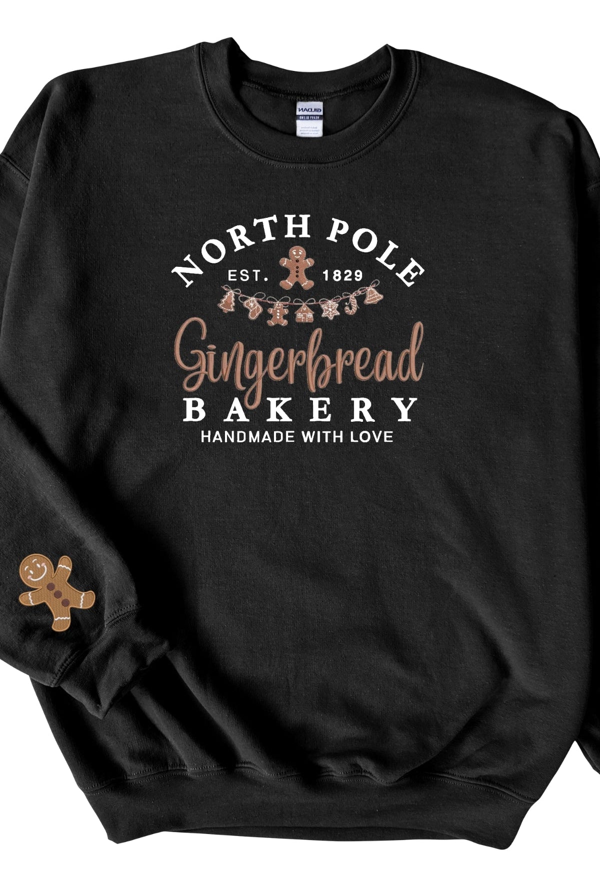 A black sweatshirt with 'North Pole Gingerbread Bakery' embroidered on the chest and a small embroidered gingerbread man on the right sleeve.