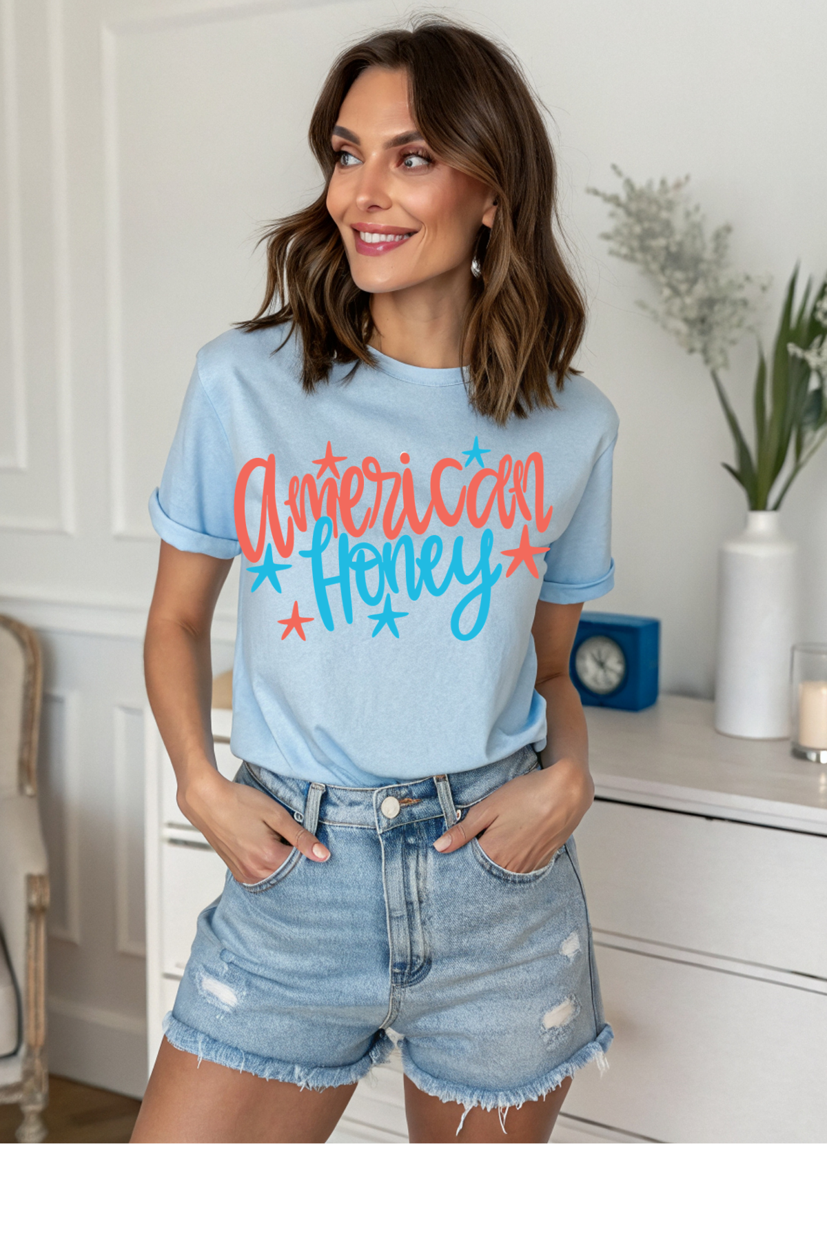 Woman wearing a light blue t-shirt with 'American Honey' text in a home setting