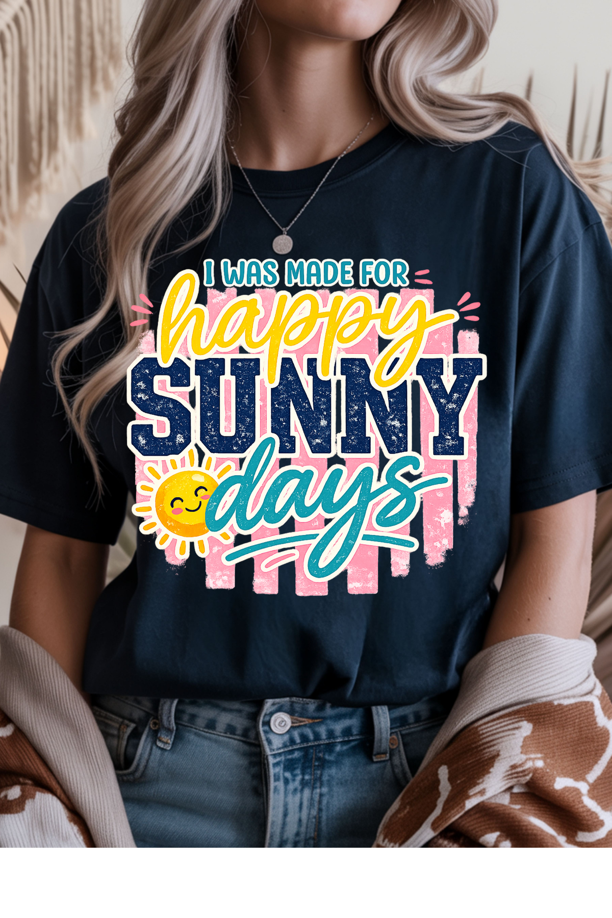 Person wearing a black t-shirt with 'happy sunny days' text design.