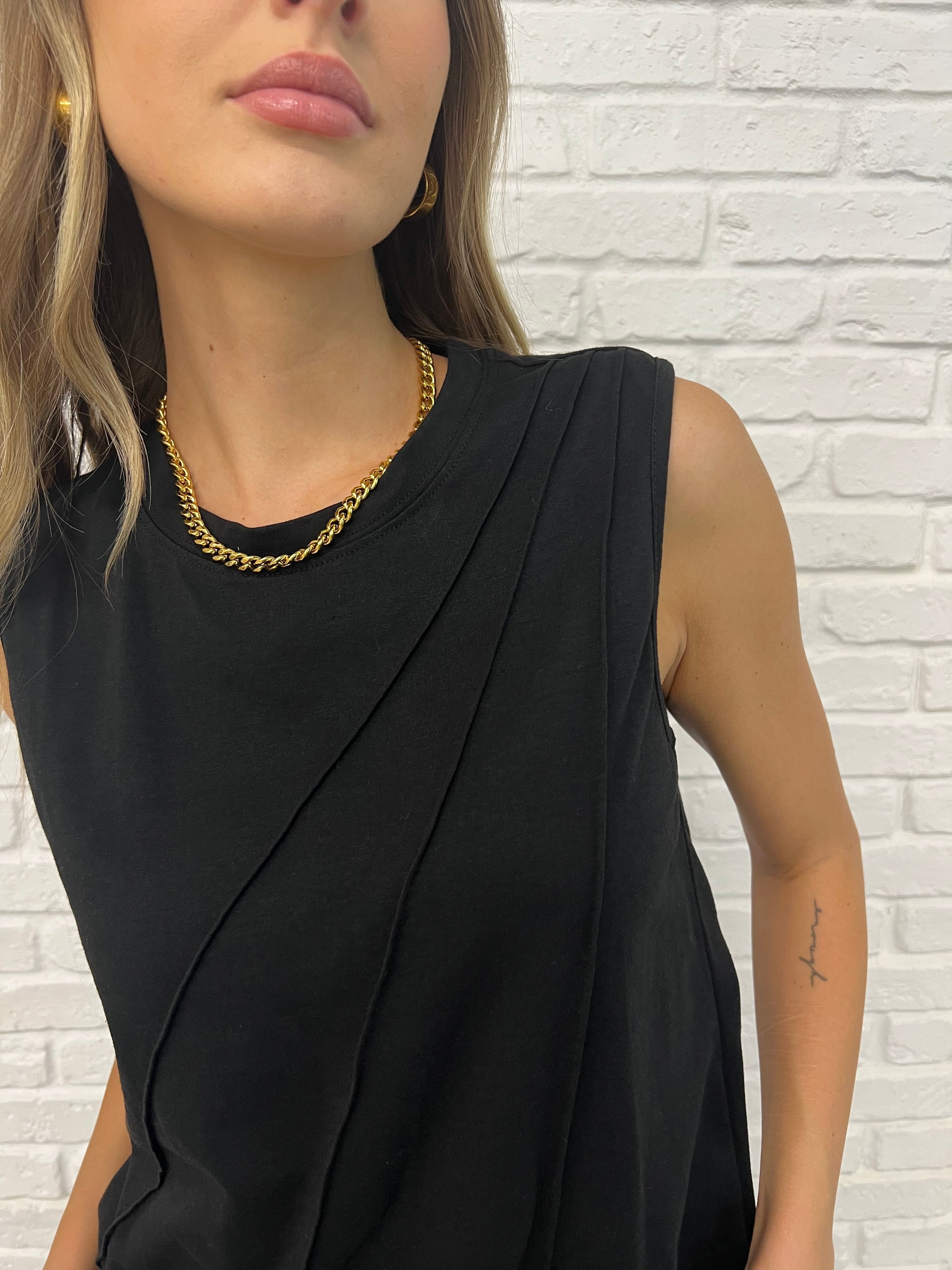 Close detail Black Sleeveless Top with diagonal pleats