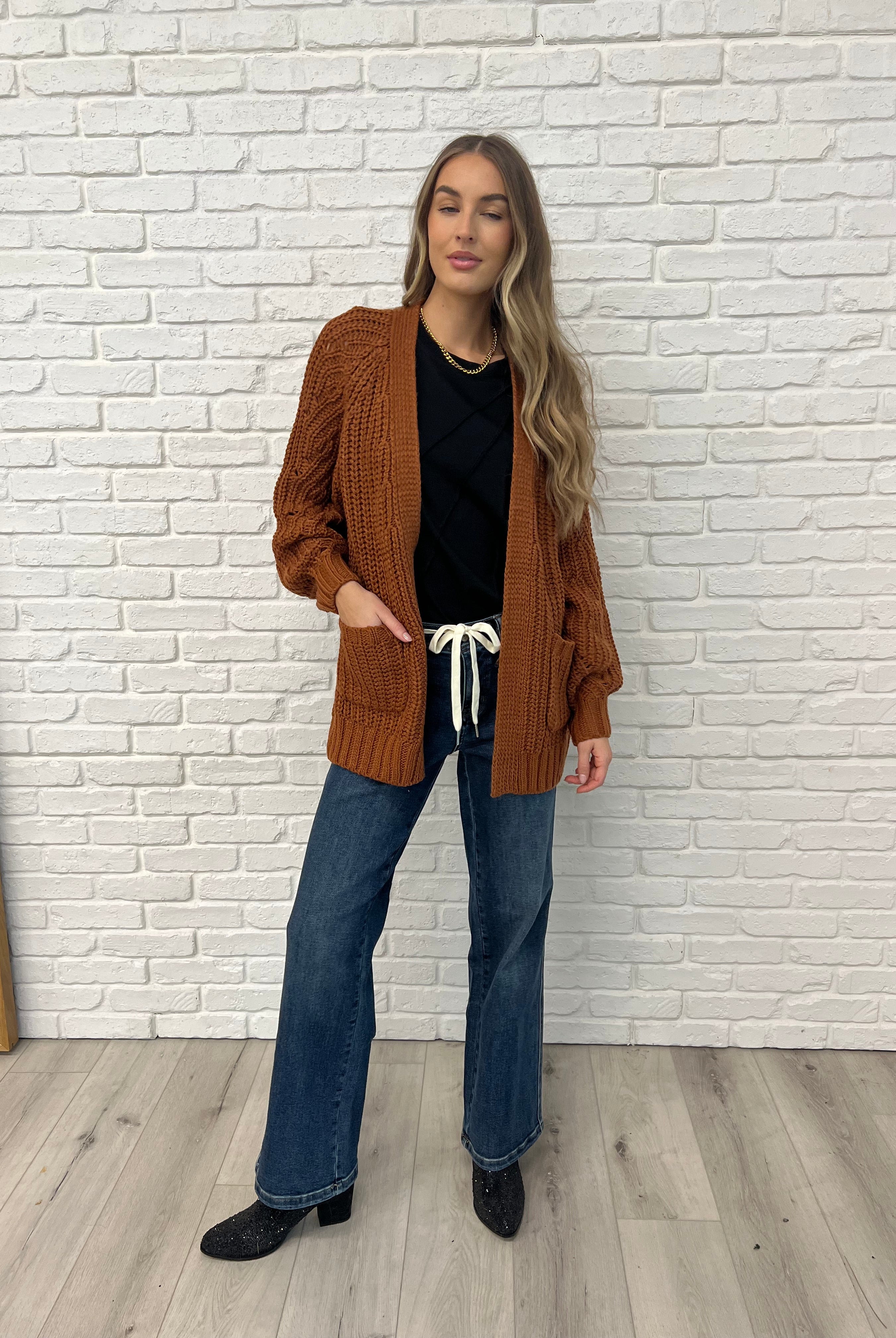 Black  Sleeveless Top with diagonal pleats styled with brown cardigan