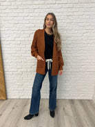 Black  Sleeveless Top with diagonal pleats styled with brown cardigan