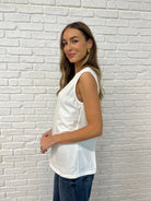 White Sleeveless Top with diagonal pleats  side view with relaxed arm opening