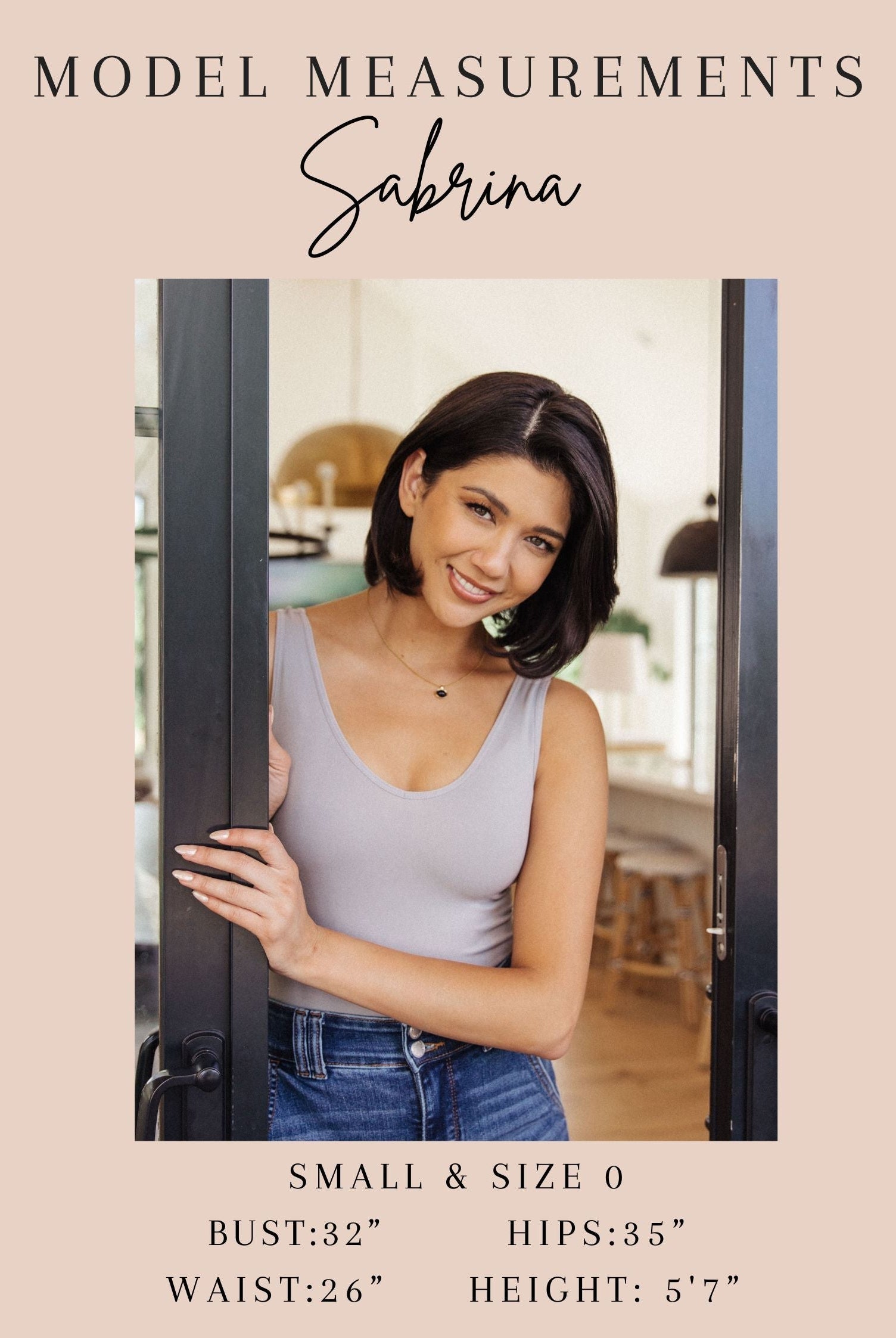 Model Sabrina standing in a doorway with her model measurements displayed