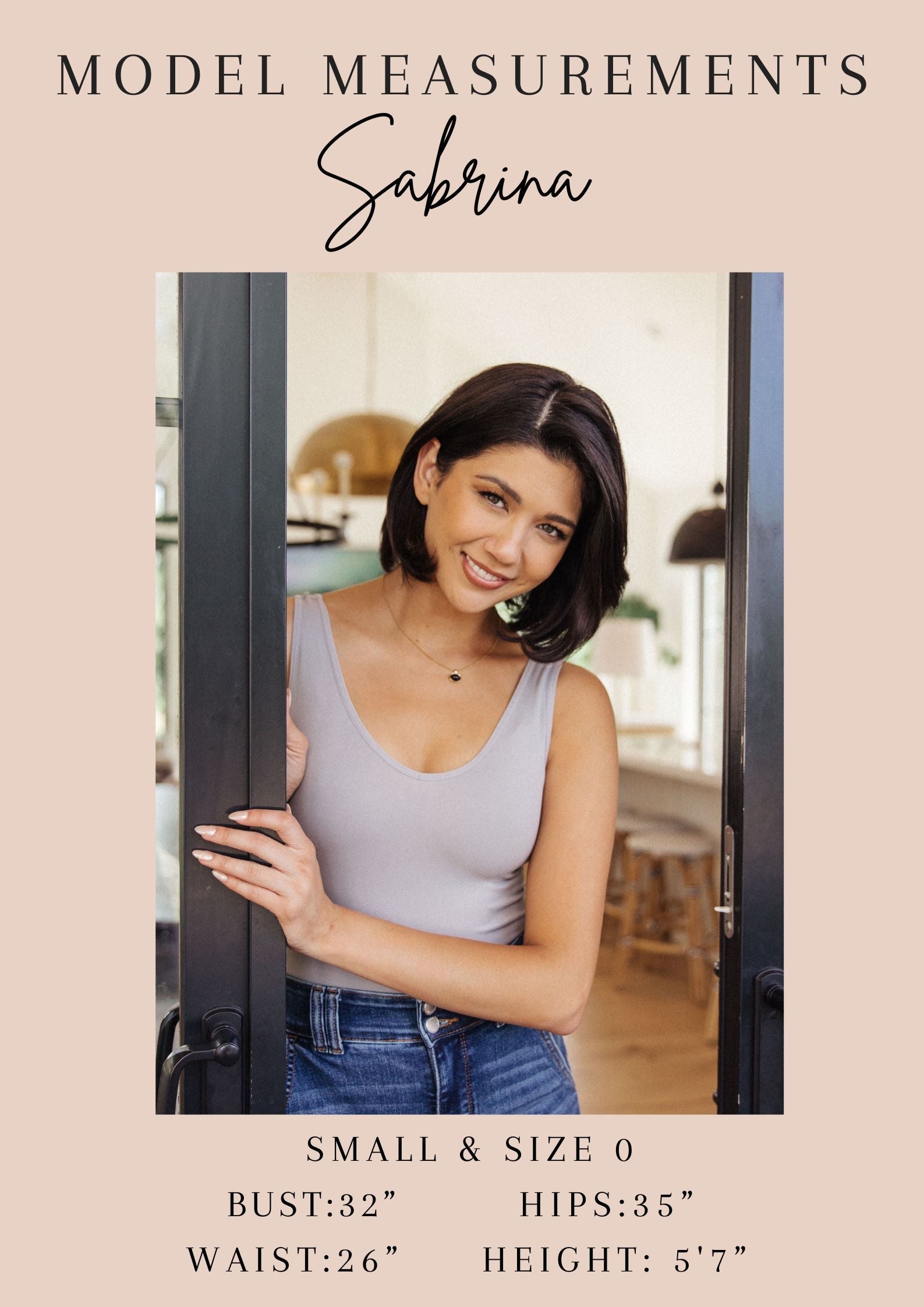 Model Sabrina standing in a doorway with her model measurements displayed