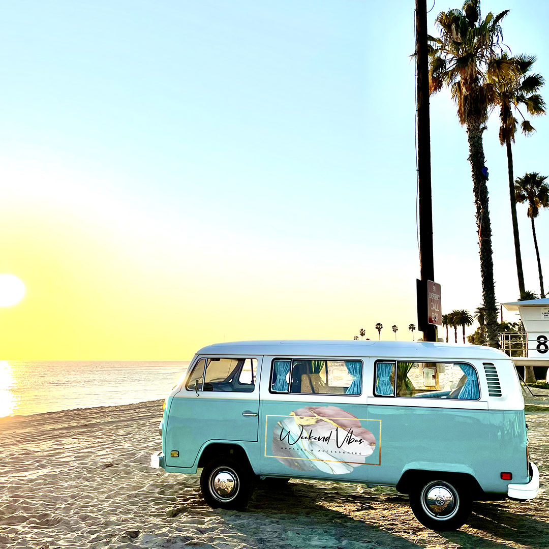Footer image of sunset with blue Volkswagen bus with company logo parked on the beach