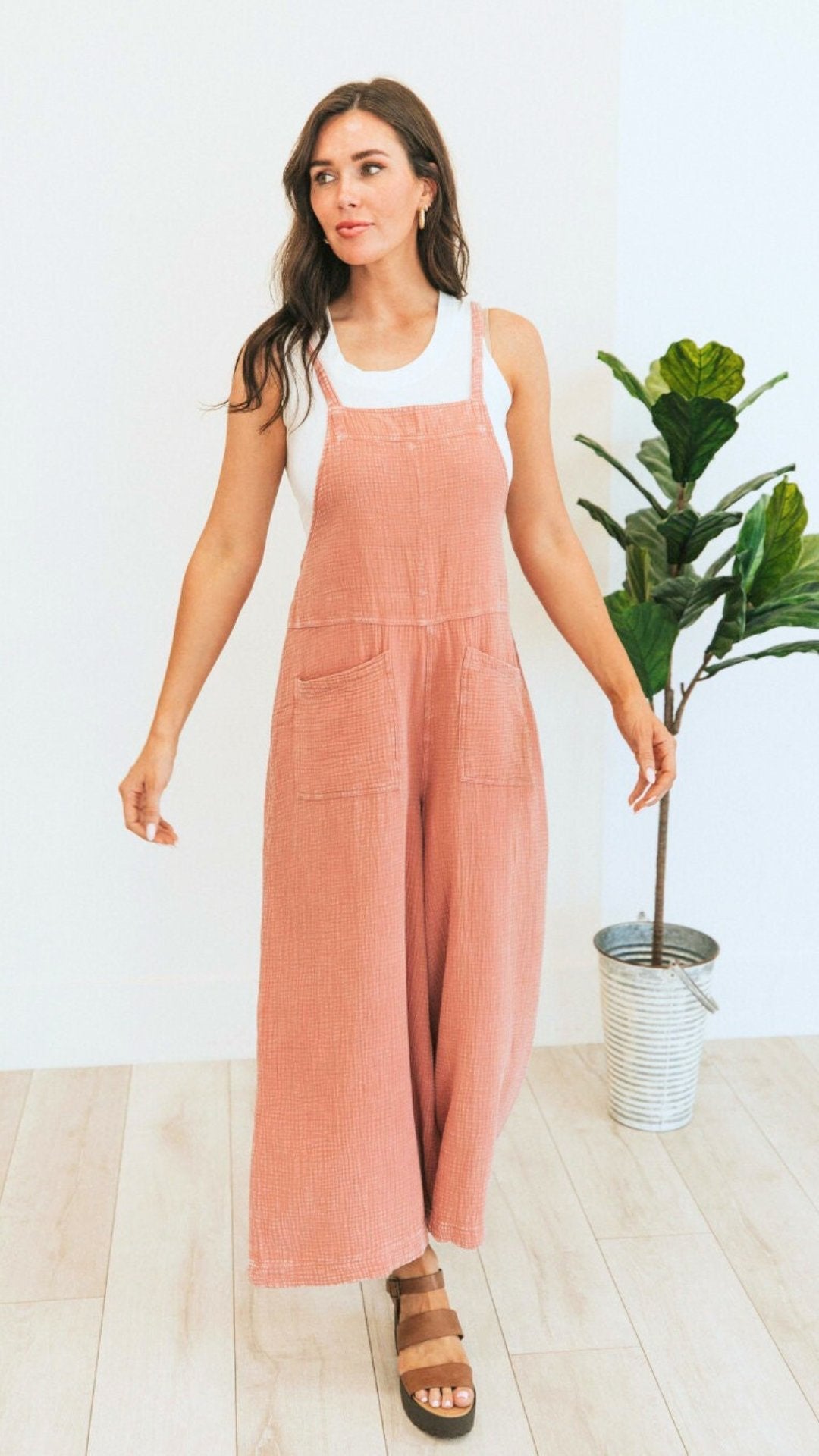 Brunette model in Soft coral corduroy overalls