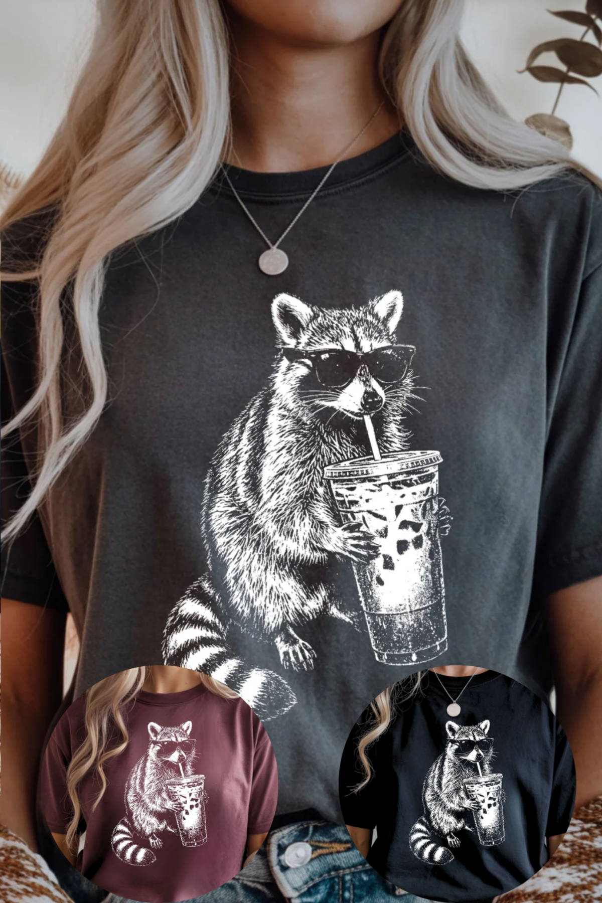 Person wearing a dark gray t-shirt with a raccoon graphic holding a coffee cup, surrounded by smaller versions of the same design on other shirts.