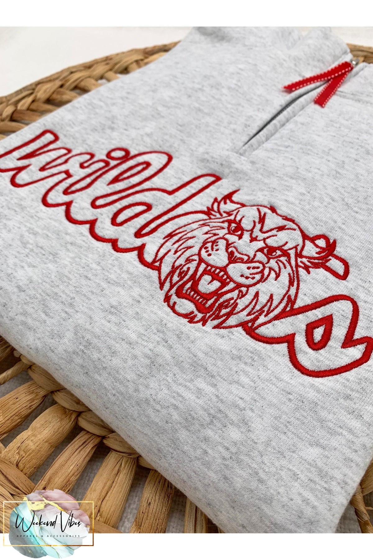 Wildcats sports team mascot embroidered on a 1/4 zip ash gray sweatshirt. Thread color is red. Thread color is customizable! 