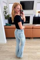 Caroline Mid Rise Control Top Distressed Flare Jeans rear view on Amanda