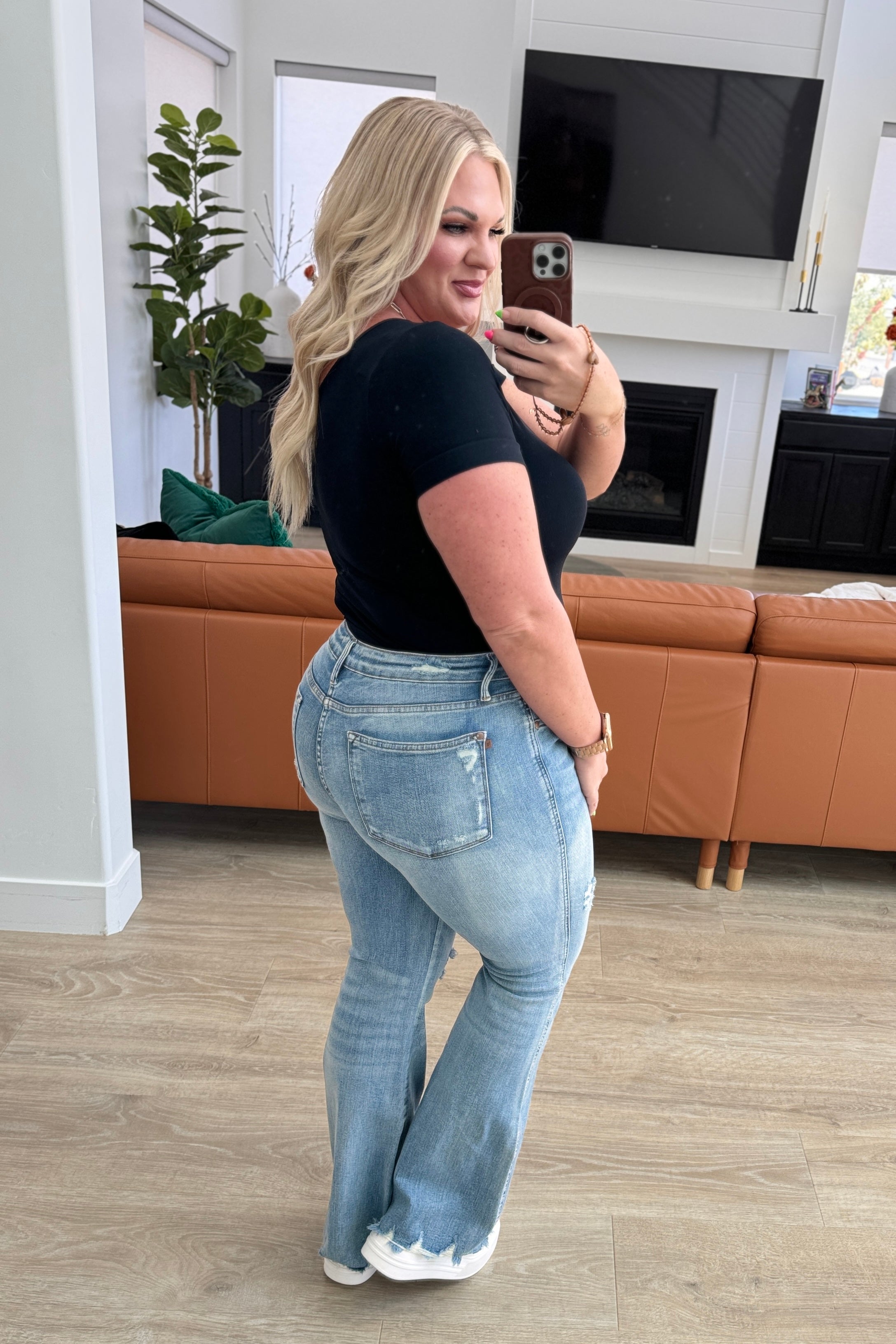 Caroline Mid Rise Control Top Distressed Flare Jeans rear view on Kira