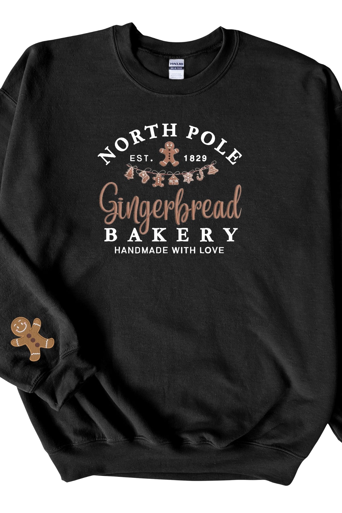 A black sweatshirt with 'North Pole Gingerbread Bakery' embroidered on the chest and a small embroidered gingerbread man on the right sleeve.
