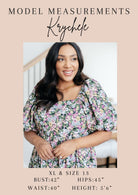 Model measurements for Krychele with a photo of her wearing a floral dress indoors.