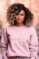Let it Snow on pink pullover crewneck sweatshirt with white font and snowflakes