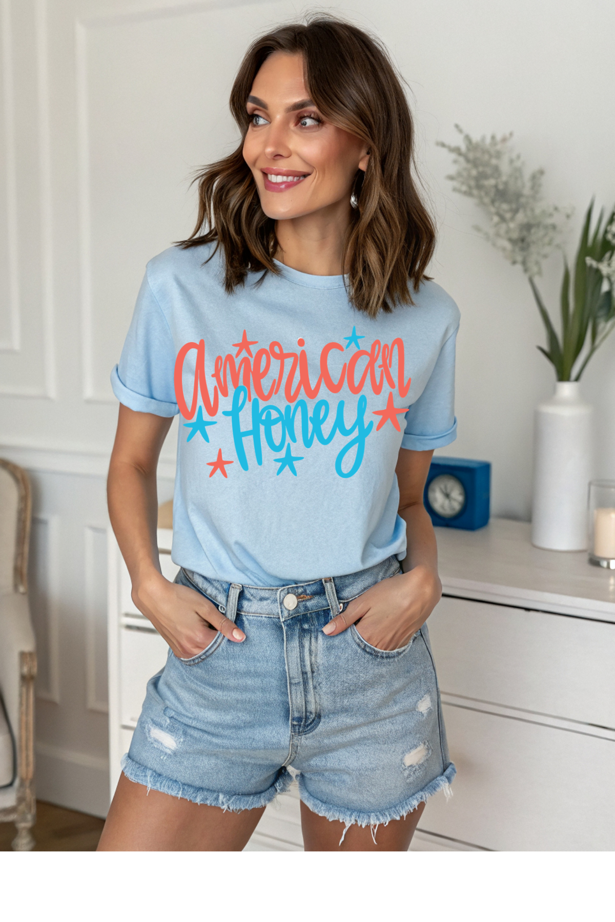 Woman wearing a light blue t-shirt with 'American Honey' text in a home setting