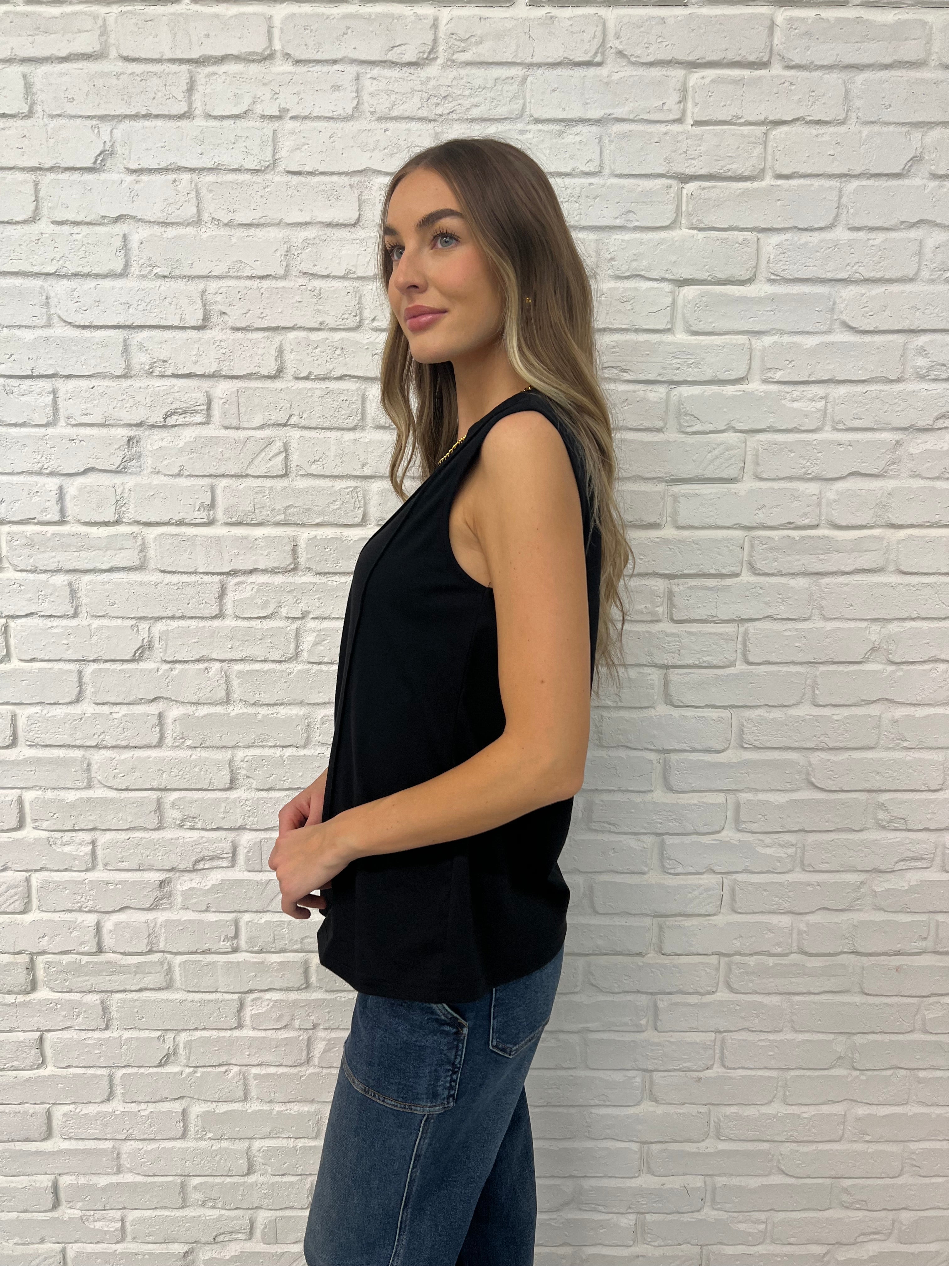 Black Sleeveless Top with relaxed arm opening and diagonal pleats 
