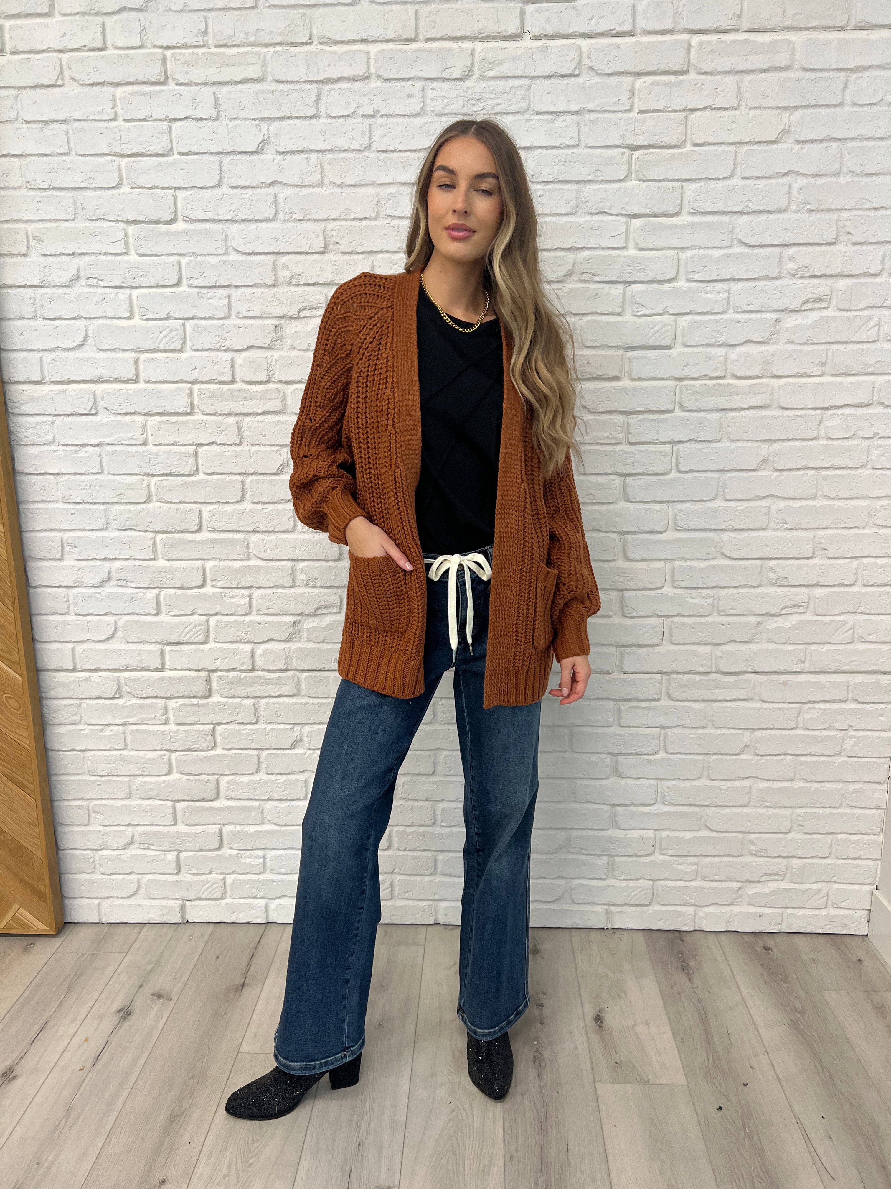 Black  Sleeveless Top with diagonal pleats styled with brown cardigan