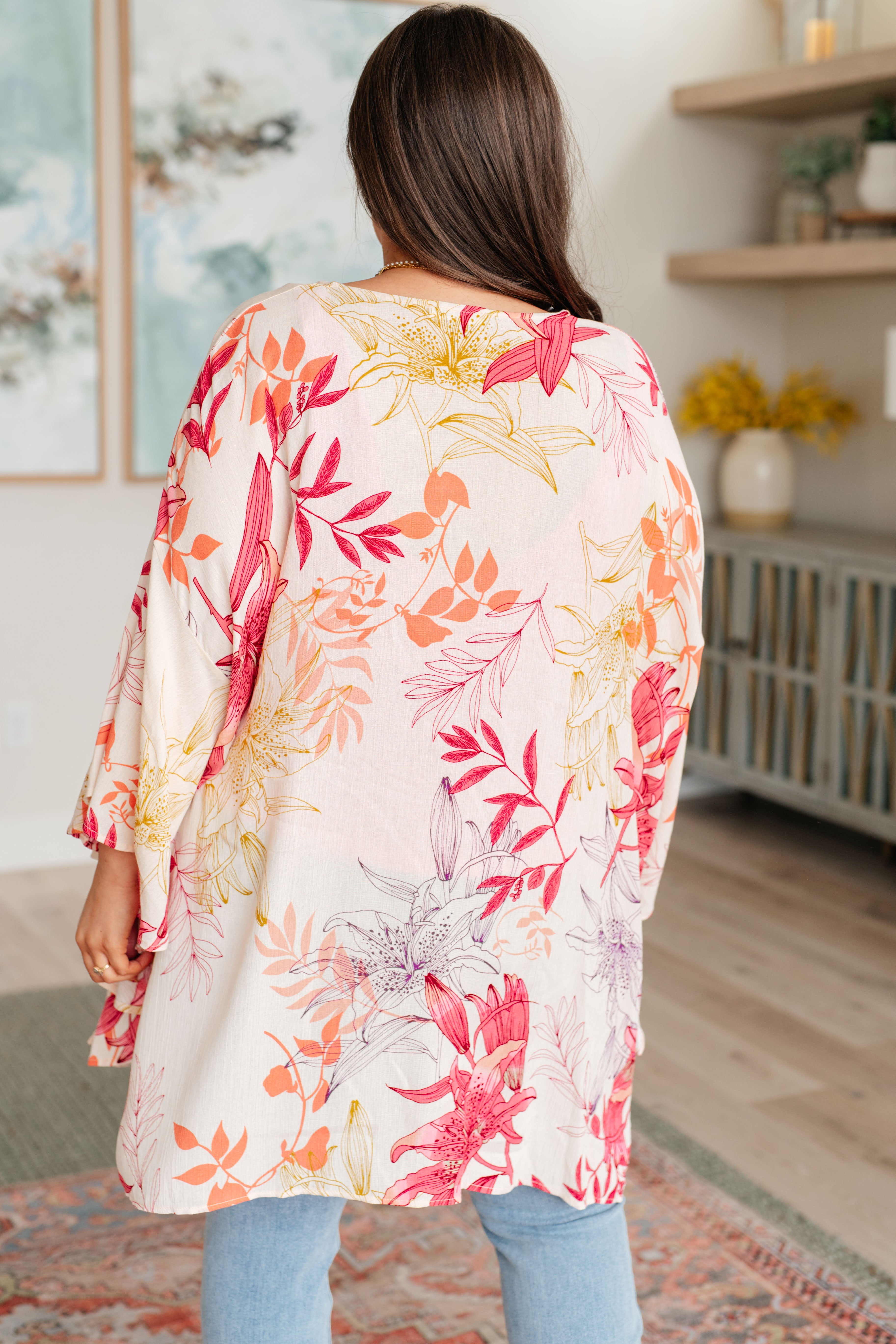 Person wearing a floral kimono in a home setting