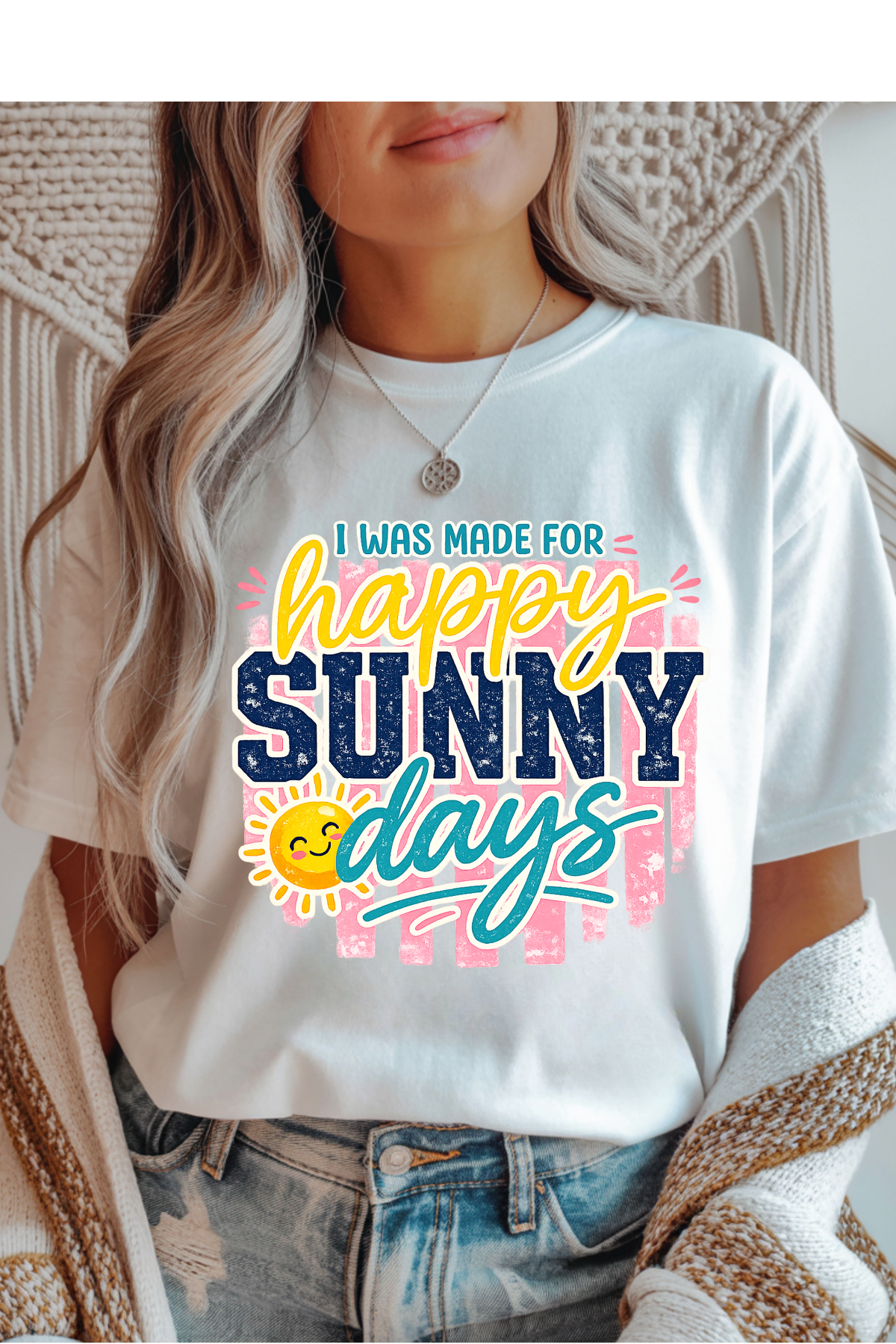Person wearing a white t-shirt with 'I was made for happy sunny days' text and sun graphic.